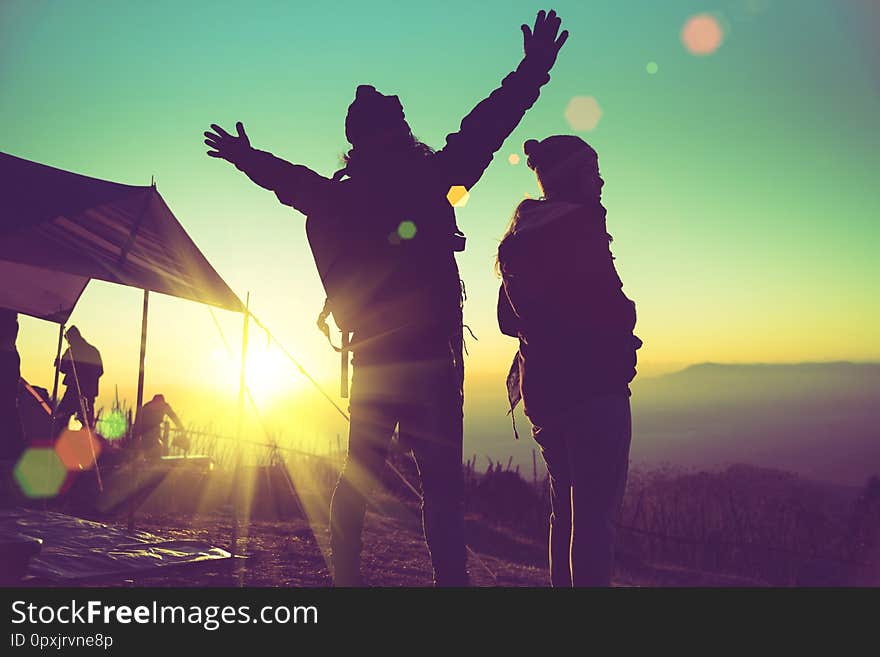 Lover woman and man asians travel relax camping in the holiday. On the Moutain. Stand watch the sun rise. Thailand