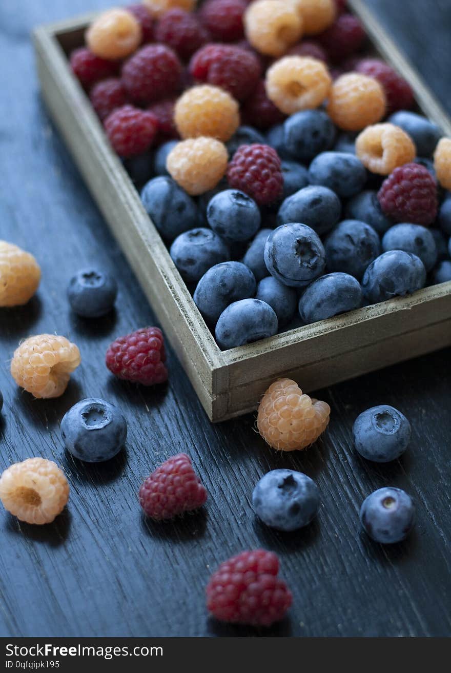 A tasty and healthy snack: a box of raspberries and blueberries