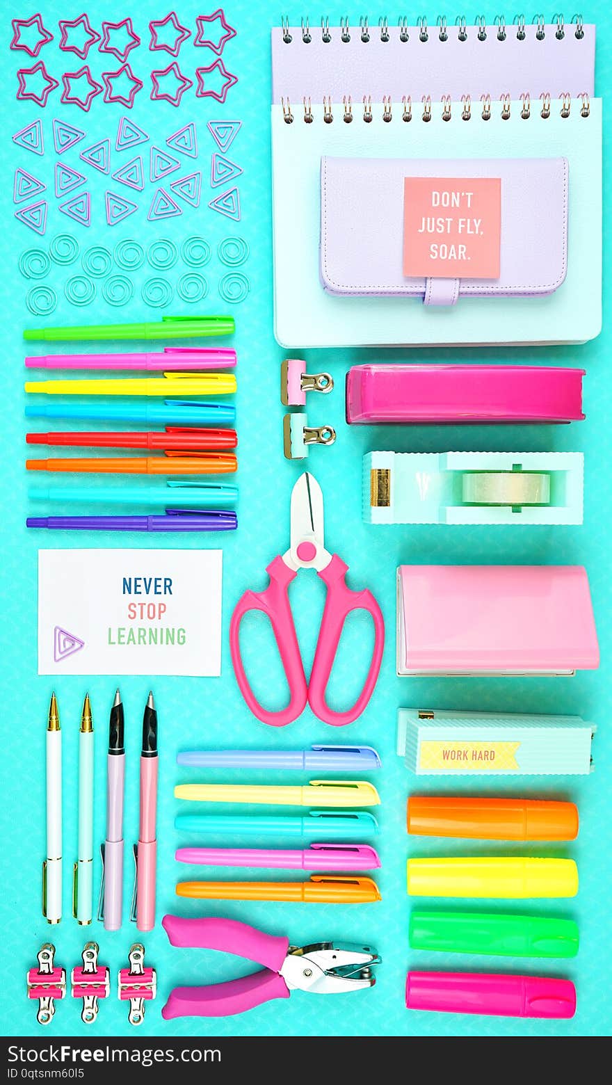 Back to school or workspace colorful stationery on aqua blue background, overhead flat lay. Back to school or workspace colorful stationery on aqua blue background, overhead flat lay.