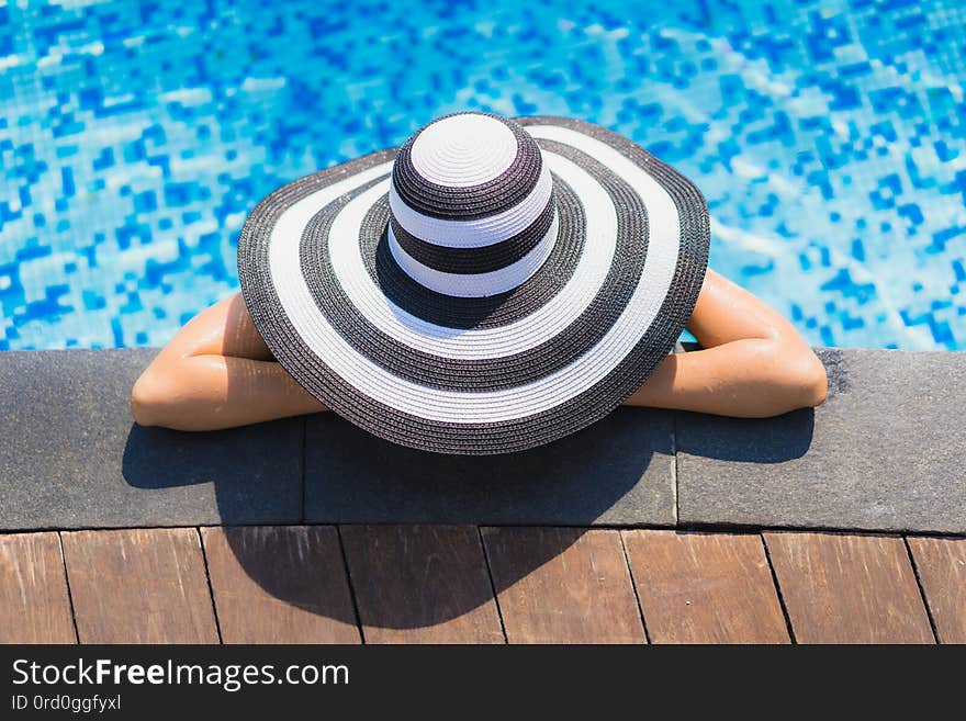 Portrait beautiful young asian woman happy smile relax around swimming pool in hotel resort