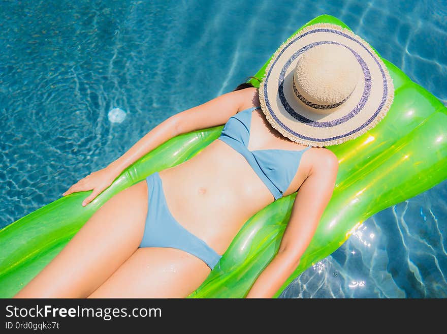 Portrait beautiful young asian woman smile happy relax and leisure in the swimming pool