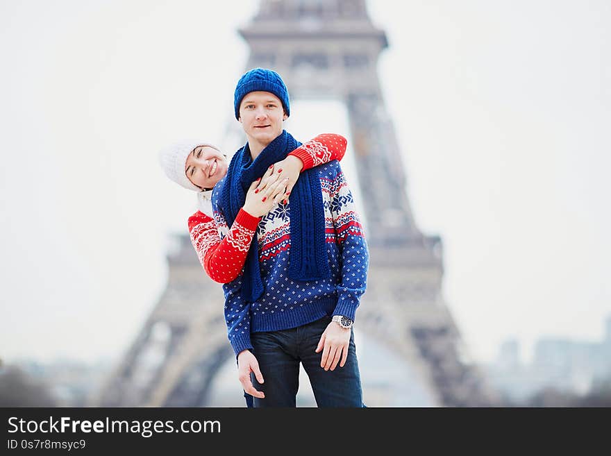 Happy couple near the Eiffel tower on a winter day