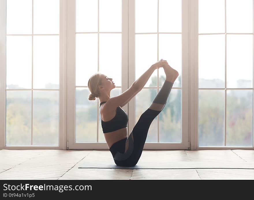 Well balanced yoga pose perfomed by girl at fitness studio, copy space. Well balanced yoga pose perfomed by girl at fitness studio, copy space