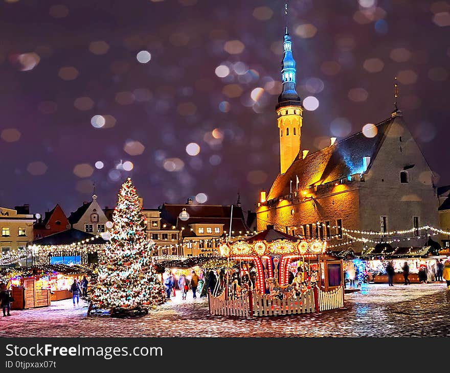 Winter night ,Christmas in the city  holiday New year  evening light moon and snowflakes in Tallinn old town square Christmas tree decoration light blurring , best winter market place in Estonia  holiday New year  evening light  and snowflakes fall  in Tallinn old town square Christmas tree decoration light blurring , best winter market place in Estonia. Winter night ,Christmas in the city  holiday New year  evening light moon and snowflakes in Tallinn old town square Christmas tree decoration light blurring , best winter market place in Estonia  holiday New year  evening light  and snowflakes fall  in Tallinn old town square Christmas tree decoration light blurring , best winter market place in Estonia