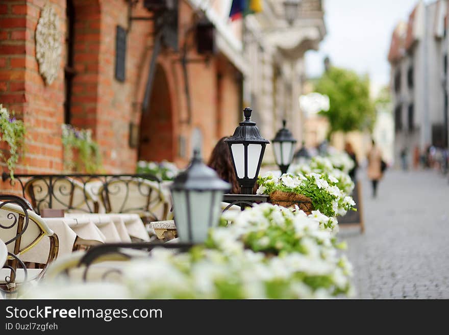 Outdoor restaurant table beautifully decorated with plants and flowers in Vilnius, Lithuania, on nice summer day