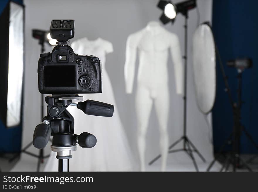 Taking pictures of ghost mannequins with modern clothes in professional photo studio, focus on camera