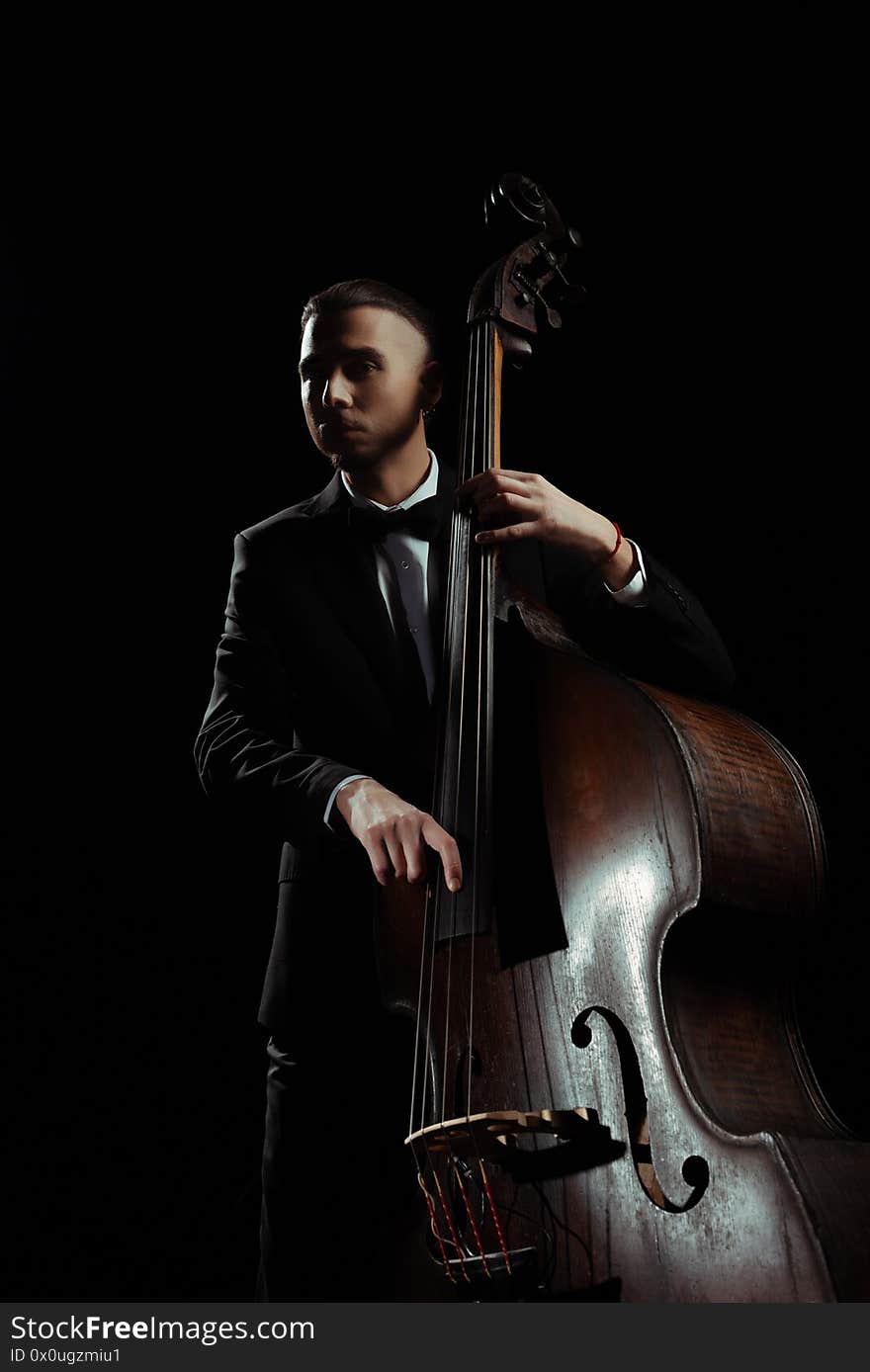 Musician playing on contrabass isolated on