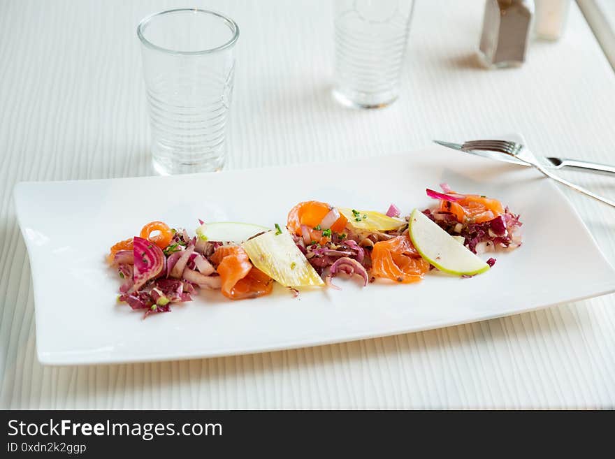 Smoked salmon salad on a white plate