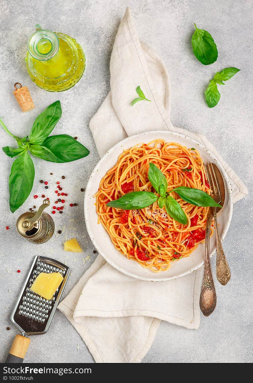 Spaghetti with tomato sauce, fresh Basil, Parmesan cheese, olive oil and spices. Mediterranean Italian cuisine. Delicious pasta