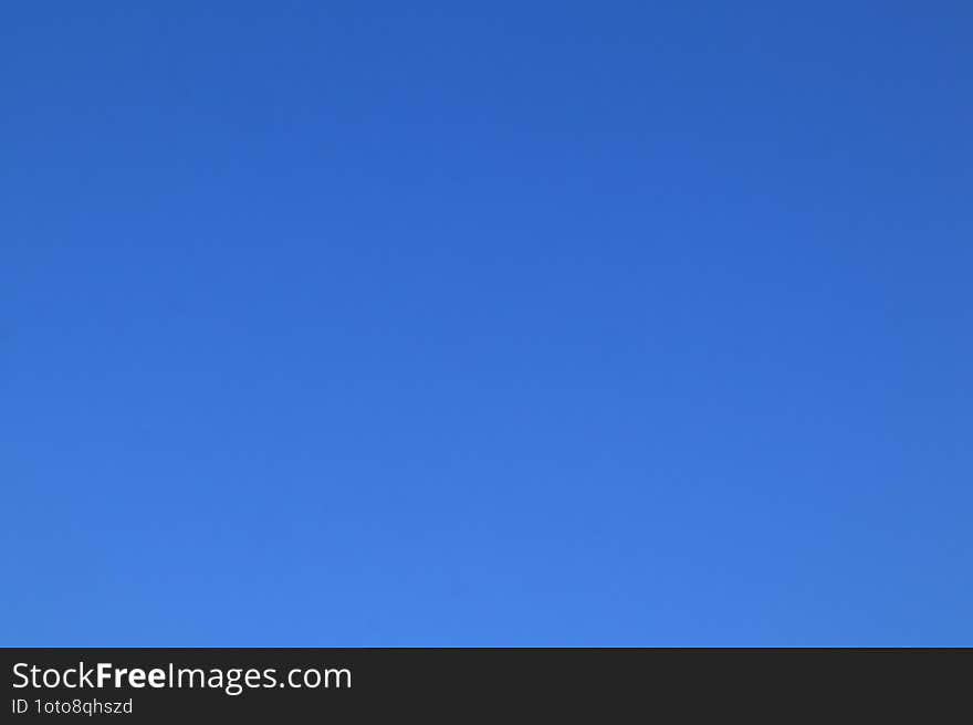 Clear blue peaceful sky early summer morning. Blue background.