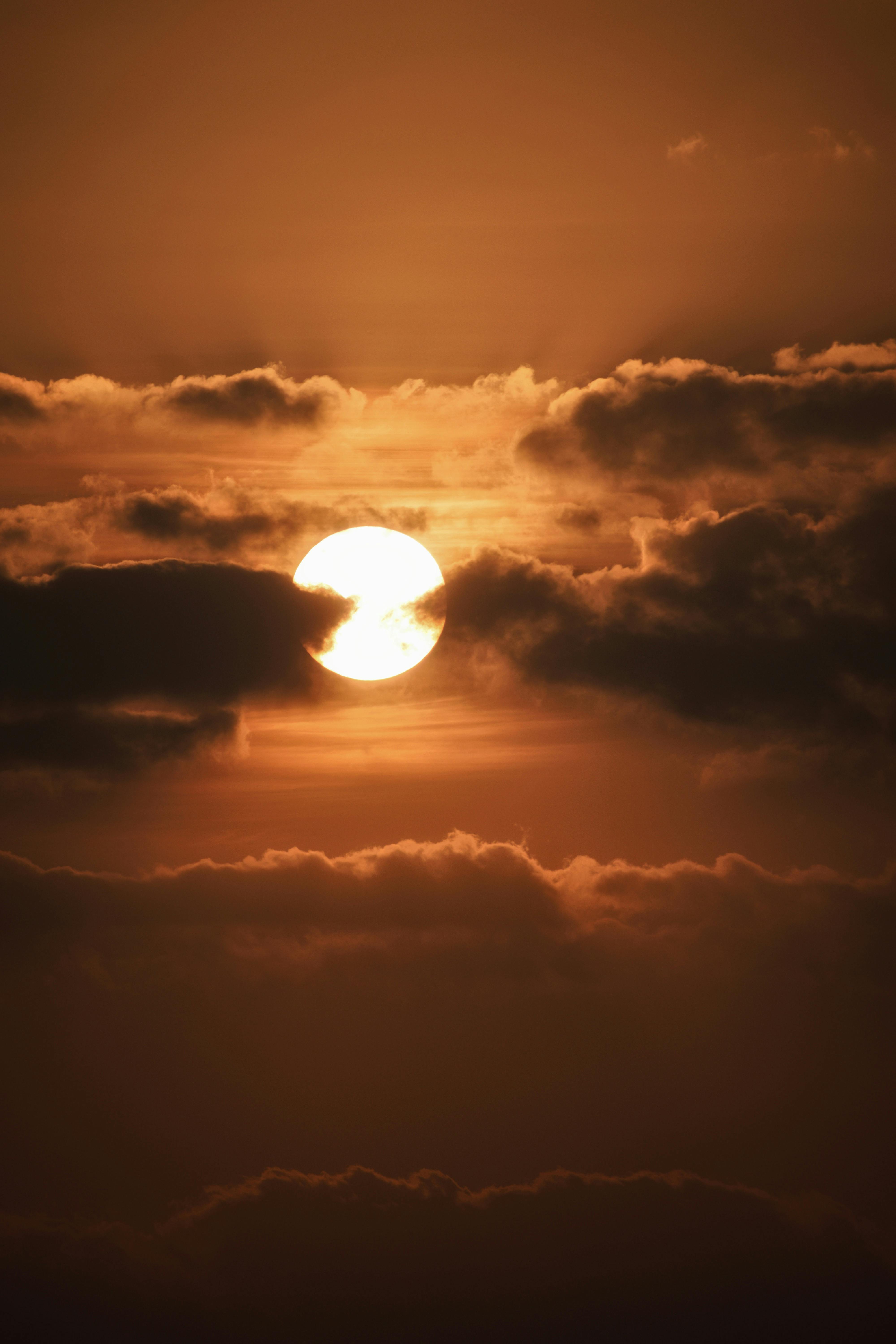 Dark clouds and sun over evening sky · Free Stock Photo