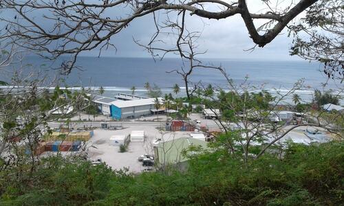Republic of Nauru Hospital and local community houses. Nauru school in the background.