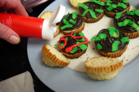 Decorating hamburger themed cupcakes.