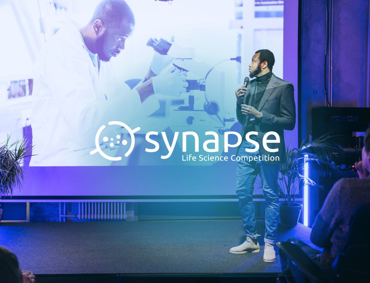 An individual pitching on stage at the Synapse Life Science Competition, an annual competition hosted by Innovation Factory