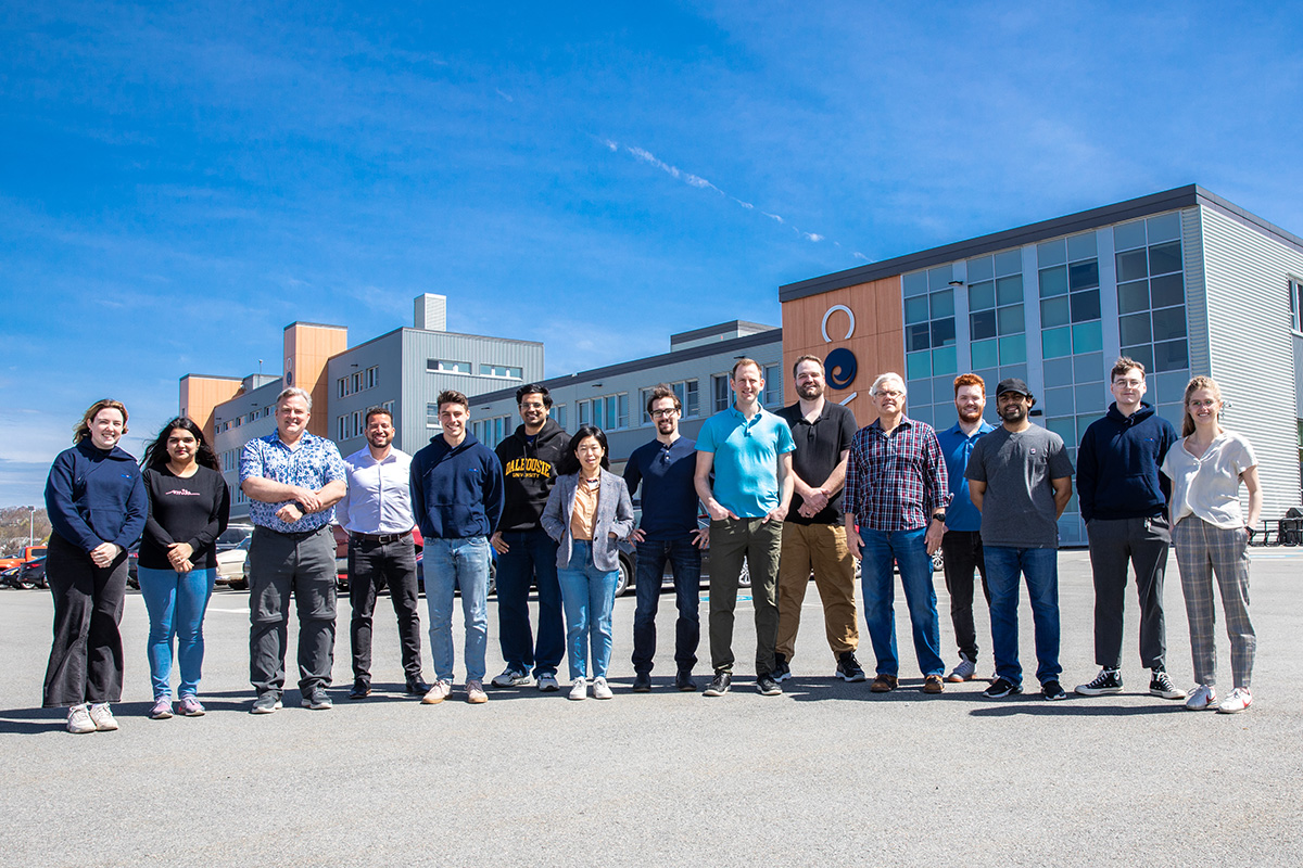 People posing outside the COVE facility on a clear day.