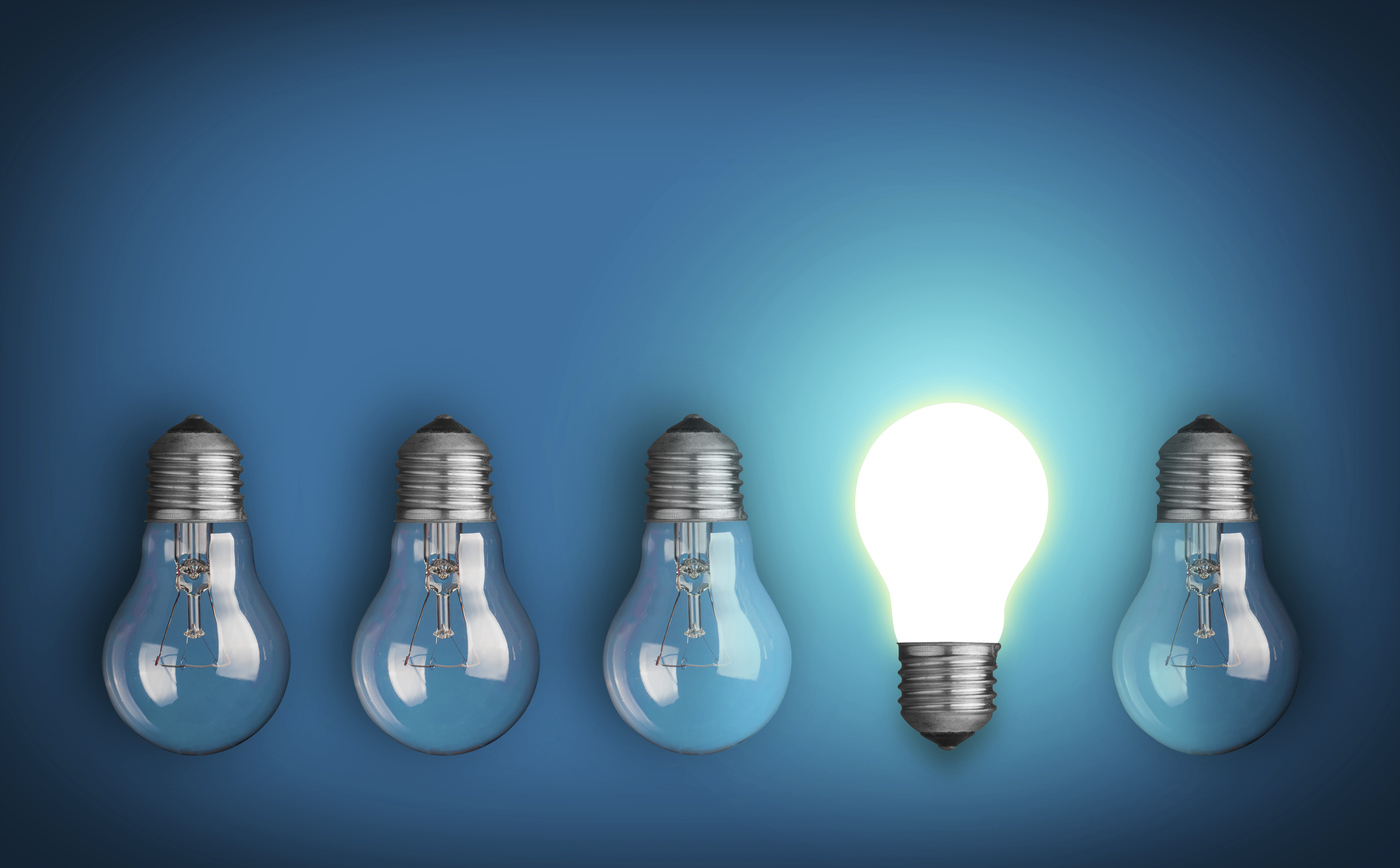 Idea concept with row of light bulbs and glowing bulb - Desktop ...