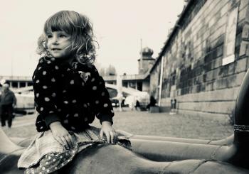 Grayscale Photo of Young Lady Sitting