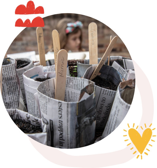 Image Description: Close up of hand made newspaper seedling pots.