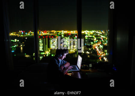 Teenage boy using a laptop. Stock Photo