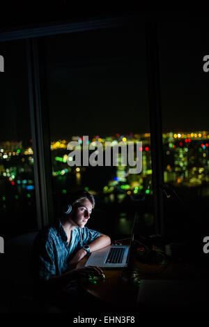 Teenage boy using a laptop. Stock Photo