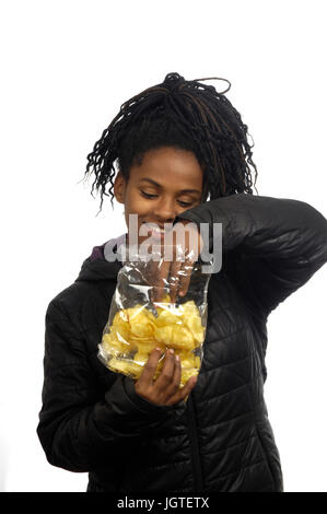 teenage girl eating chips Stock Photo