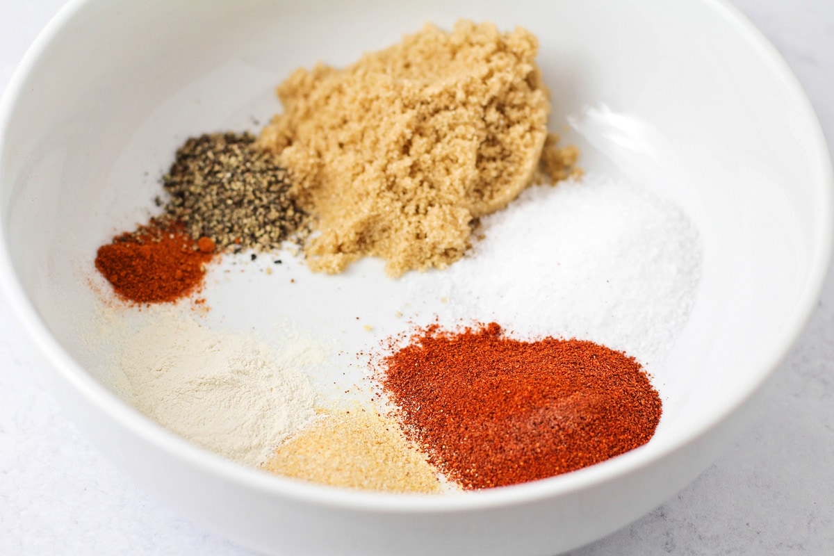 Dry seasoning for flavoring in a white bowl.