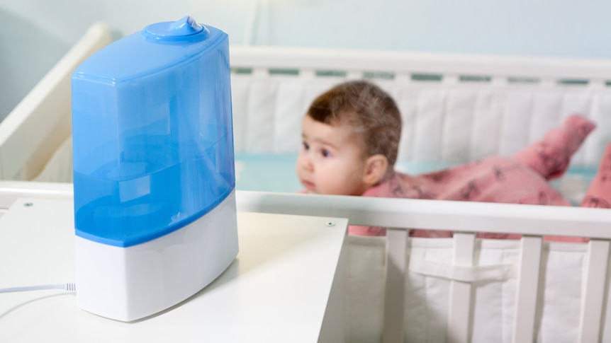 humidifier in room with baby in cot