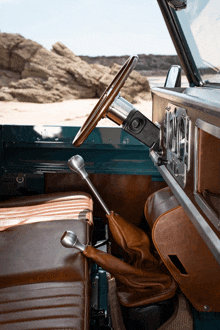 the interior of a car with a steering wheel and a shifter