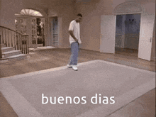 a man is standing on a rug in a room with the words buenos dias written on the floor