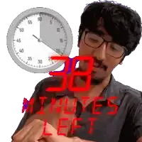 a man wearing glasses is looking at his watch with a clock in the background that says 38 minutes left