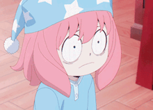 a girl with pink hair wearing a blue hat with white stars on it