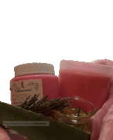 a pink container of chamani sits next to a glass