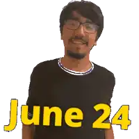 a man wearing glasses and a black shirt with the date june 24 on it