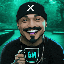 a man wearing a hat with the letter x on it holds a cup with the letter gm on it