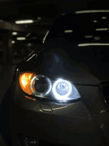 a close up of a car 's headlights in a dark garage