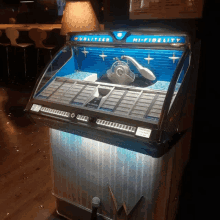 a wurlitzer hi-fidelity jukebox with a microphone in front of it