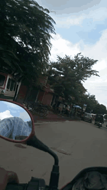 a person riding a motorcycle looking at their reflection in the mirror