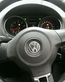 a close up of a volkswagen steering wheel with airbag on it