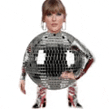 a woman is wearing a disco ball costume and standing on a white background .