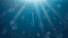 a fishing hook in the middle of the ocean with bubbles around it