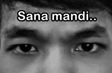 a black and white photo of a man 's eyes with sana mandi written above them