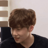 a close up of a person 's face with a black shirt