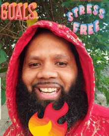 a man with a beard wearing a red hoodie with the words " goals stress free " on it