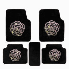 a set of black car mats with a flower design