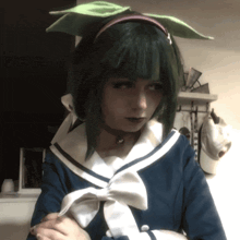 a girl with green hair and a sailor outfit