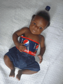 a baby with a pepsi bottle around his neck