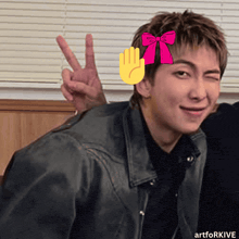 a man in a leather jacket giving a peace sign with a pink bow on his head