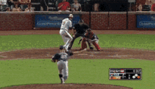 a baseball game is being played in front of a brick wall with a banner that says champions on it