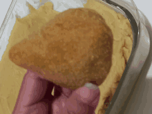 a close up of a person holding a piece of bread