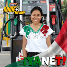 a woman stands in front of a gas pump with a sign that says rinda y mas es mejor on it